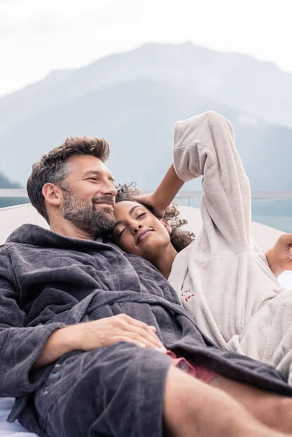 Couple on a lounger in a luxury hotel in Zillertal STOCK resort